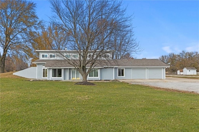 view of front of house with a front yard and a garage