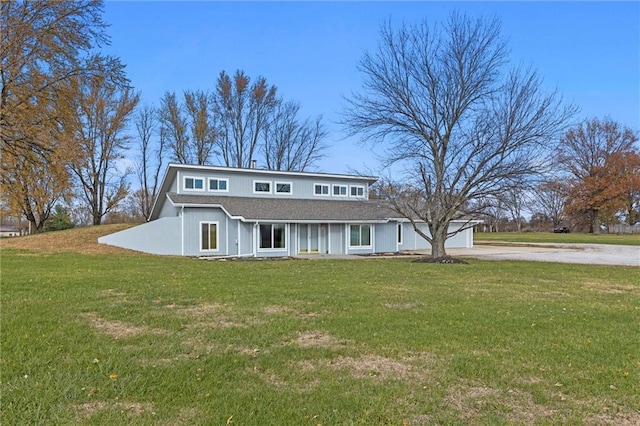 view of front of property with a garage and a front lawn