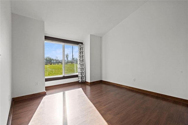 empty room with dark hardwood / wood-style flooring