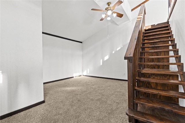 interior space with carpet flooring, ceiling fan, and lofted ceiling