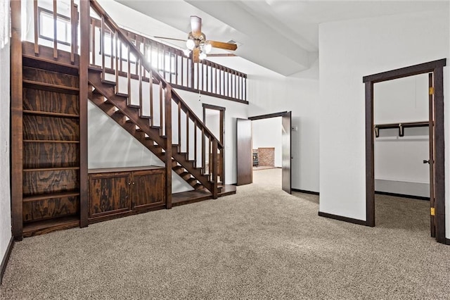 unfurnished living room featuring carpet flooring and ceiling fan