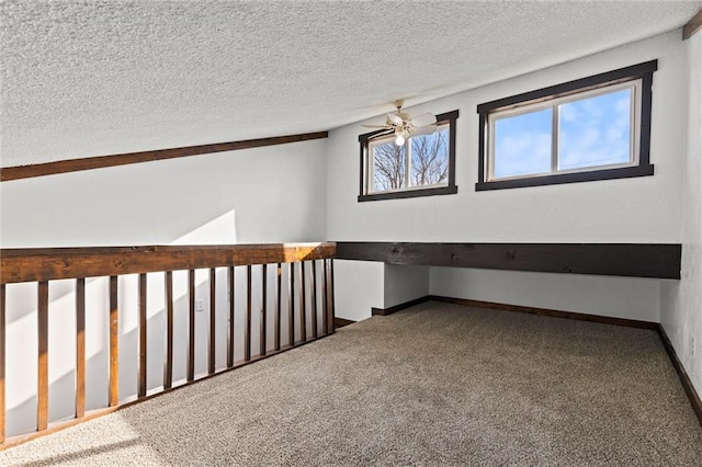 interior space with ceiling fan, carpet floors, and a textured ceiling