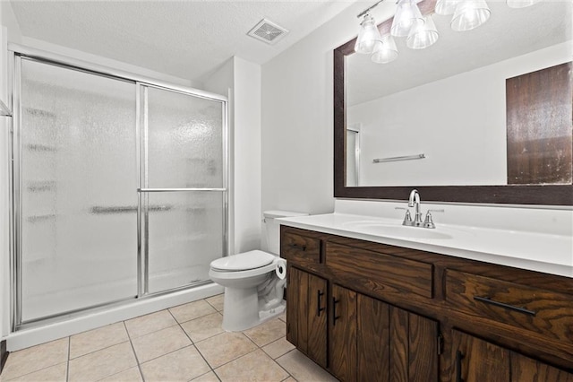 bathroom featuring a textured ceiling, vanity, a shower with door, tile patterned flooring, and toilet