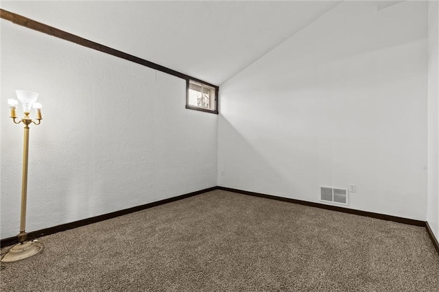 unfurnished room featuring carpet flooring and lofted ceiling