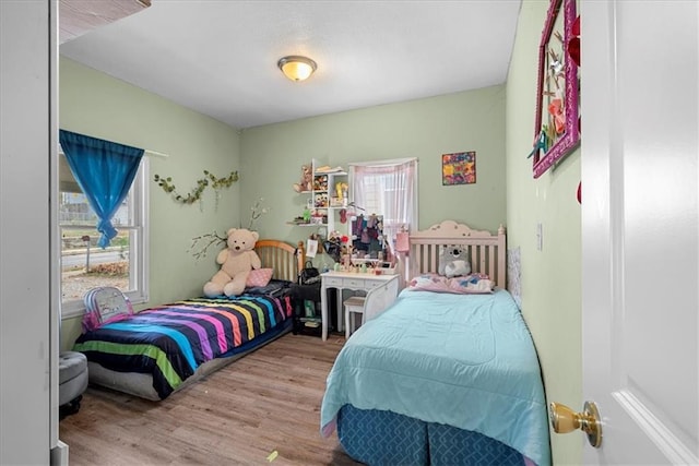 bedroom featuring light hardwood / wood-style floors and multiple windows