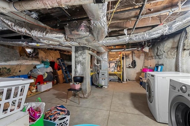 basement with heating unit and washing machine and clothes dryer