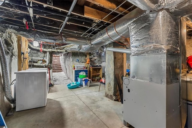 basement with heating unit and washer / dryer