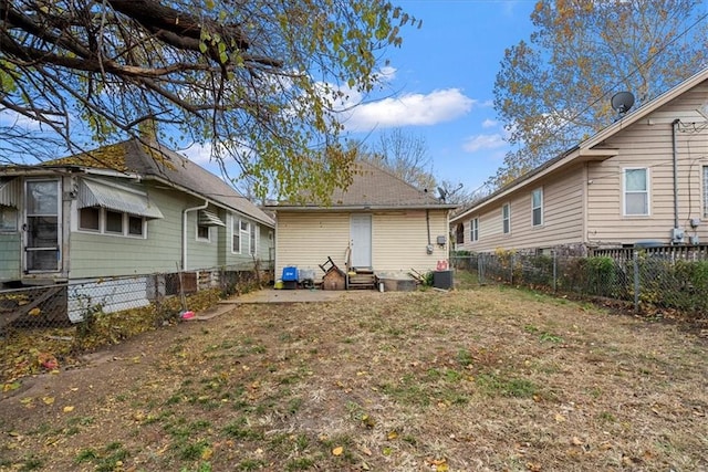 back of house with central AC unit