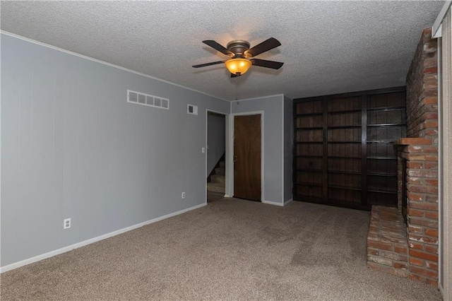 unfurnished bedroom featuring a textured ceiling, carpet floors, and ceiling fan