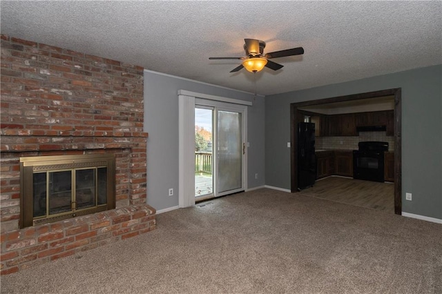 unfurnished living room with carpet flooring, a textured ceiling, and a brick fireplace