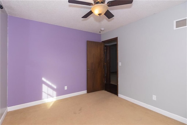 unfurnished bedroom with ceiling fan, carpet, and a textured ceiling