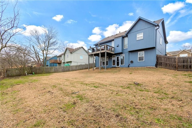 rear view of property with a yard and a deck