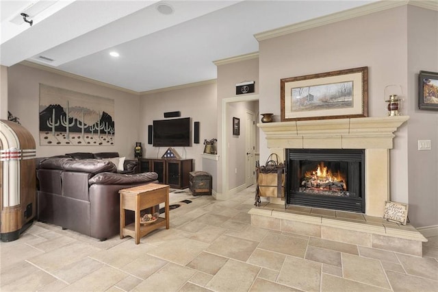 living room with ornamental molding and a tile fireplace