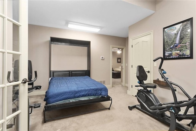 bedroom featuring light carpet