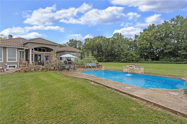 view of pool featuring a yard and a patio