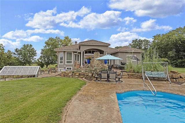 view of pool featuring a patio and a lawn