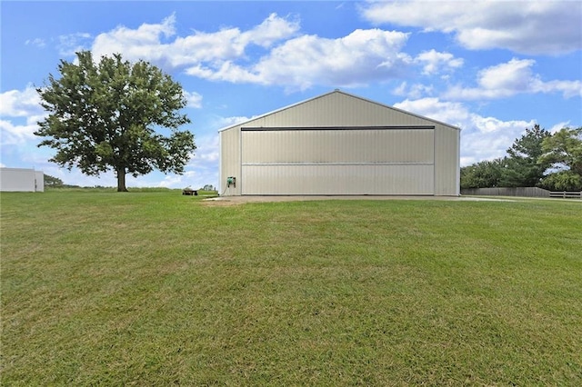 view of home's exterior with a yard and an outdoor structure