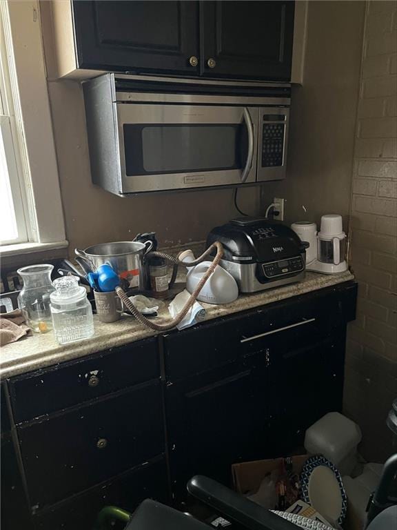 kitchen featuring light countertops and stainless steel microwave