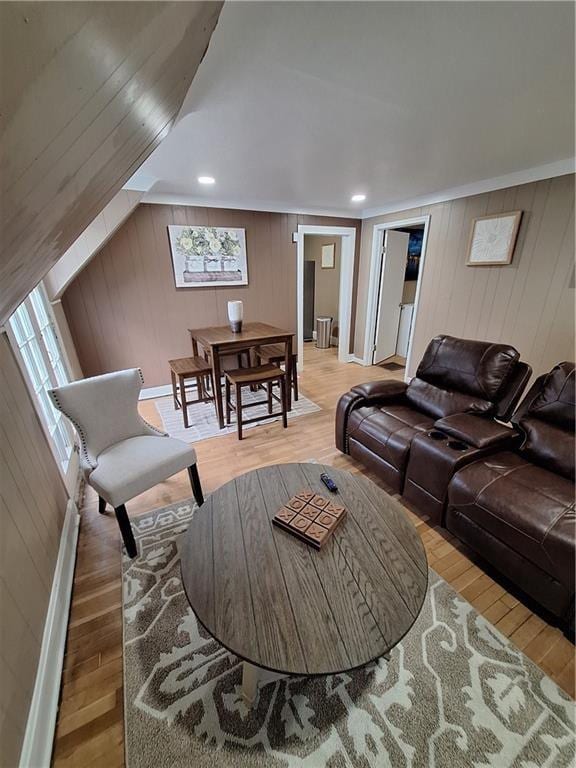 living room with hardwood / wood-style flooring and wooden walls