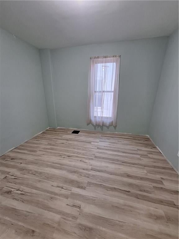 spare room with light wood-type flooring