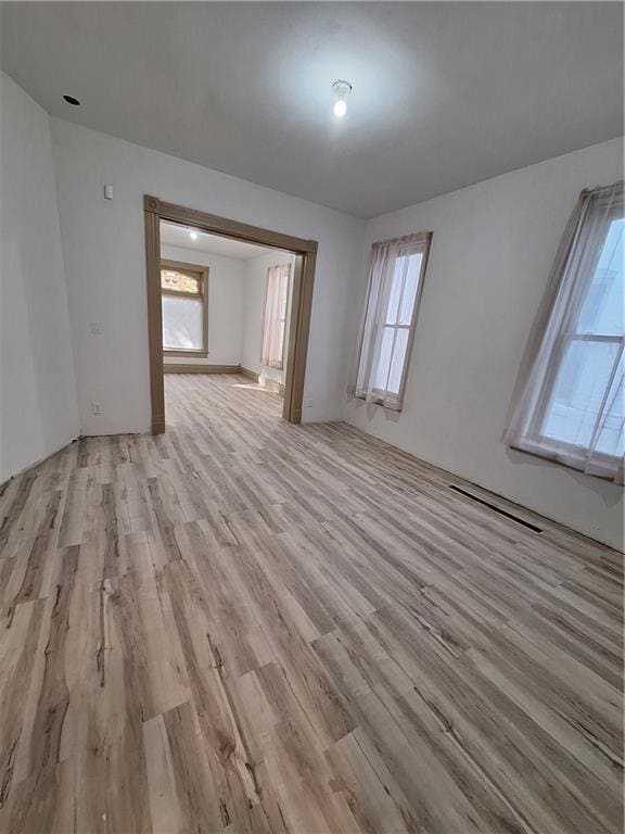 empty room with light hardwood / wood-style flooring