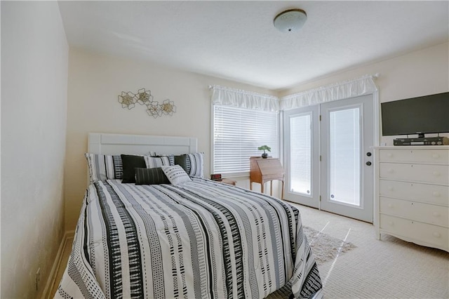 carpeted bedroom with access to outside