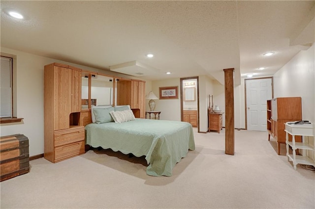 carpeted bedroom with ensuite bath