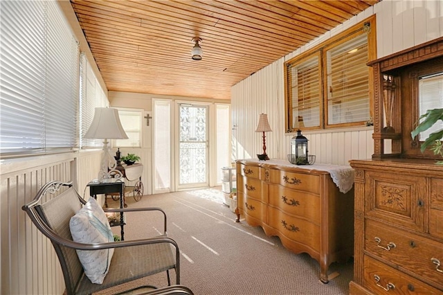 living area with light colored carpet and wood ceiling