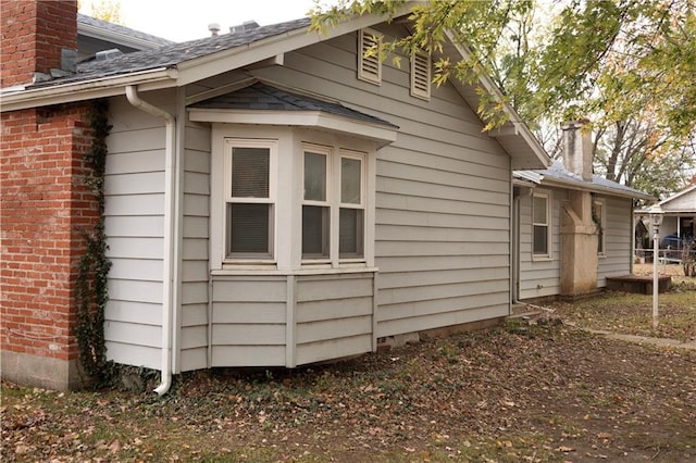 207 N Elm St, Coffeyville, KS 67337 - view of side of home featuring a chimney