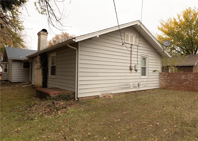207 N Elm St, Coffeyville, KS 67337 - view of side of property featuring a chimney