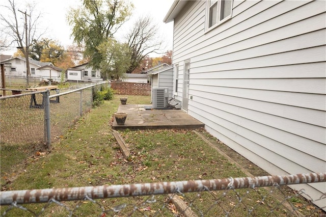 view of yard featuring a patio and central AC