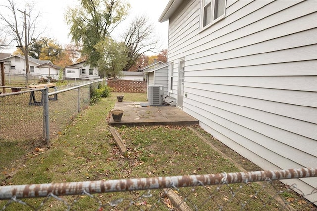 207 N Elm St, Coffeyville, KS 67337 - view of yard featuring central AC unit and a patio
