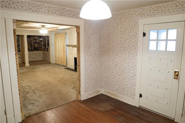 foyer entrance featuring ornamental molding and hardwood / wood-style flooring