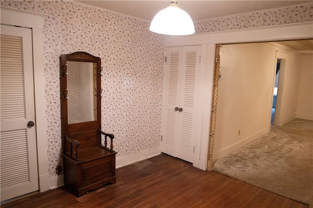 interior space with crown molding and dark hardwood / wood-style floors