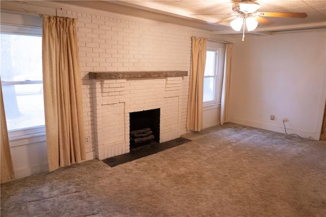 unfurnished living room featuring ceiling fan, carpet floors, and a brick fireplace