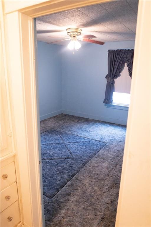 unfurnished room featuring carpet floors and ceiling fan