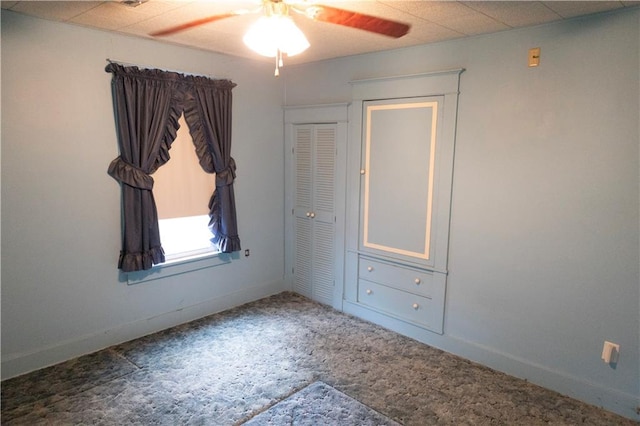 207 N Elm St, Coffeyville, KS 67337 - unfurnished bedroom featuring carpet flooring, baseboards, and ceiling fan