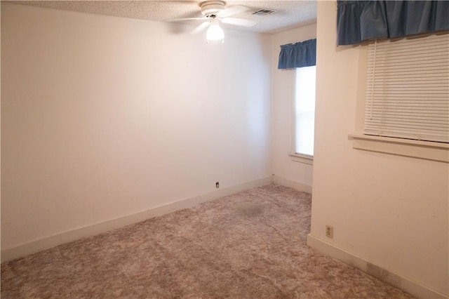 spare room with carpet flooring, a textured ceiling, and ceiling fan