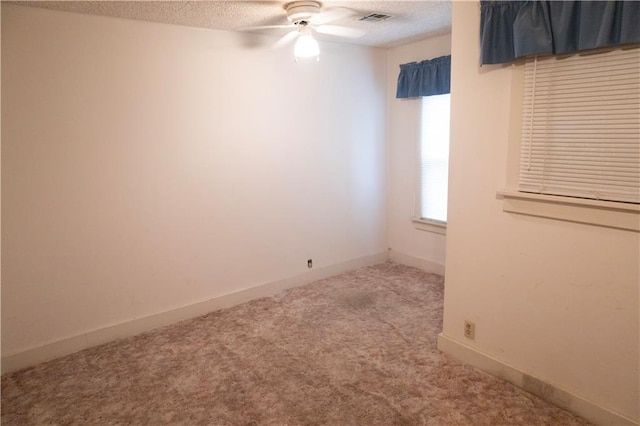 207 N Elm St, Coffeyville, KS 67337 - carpeted empty room featuring a ceiling fan, a textured ceiling, and baseboards