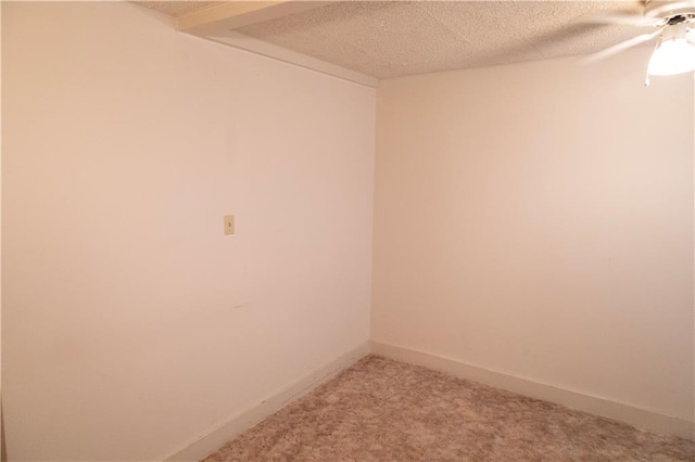 unfurnished room featuring ceiling fan, carpet floors, and a textured ceiling