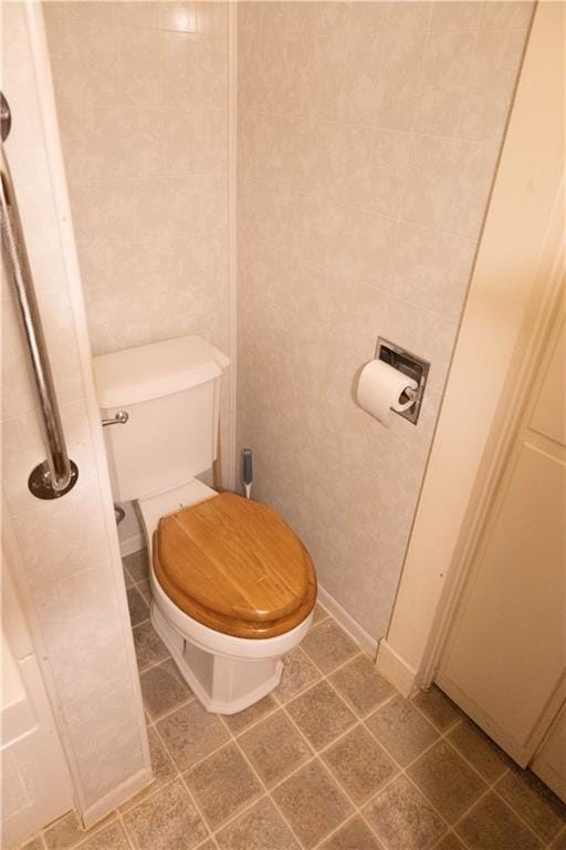 207 N Elm St, Coffeyville, KS 67337 - bathroom featuring toilet and tile patterned flooring