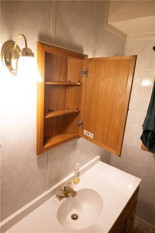 bathroom with vanity, tile walls, and tasteful backsplash