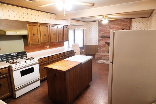 kitchen with a kitchen island, butcher block counters, and white appliances