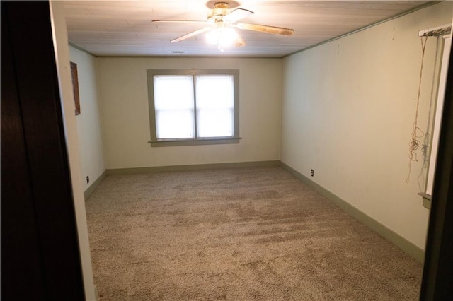 spare room featuring light carpet, ceiling fan, and wooden ceiling