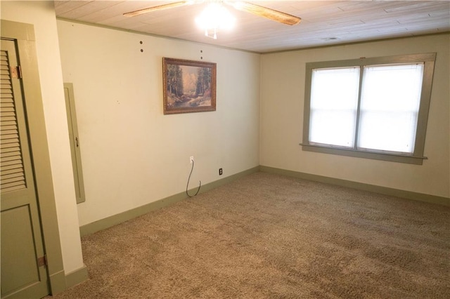 empty room with carpet, ceiling fan, and wood ceiling