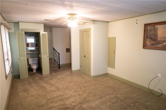 carpeted empty room with ceiling fan and wooden ceiling