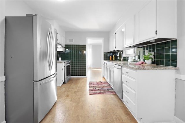 kitchen with sink, appliances with stainless steel finishes, and white cabinetry