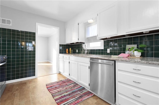 kitchen featuring sink, white cabinetry, light stone counters, stainless steel dishwasher, and decorative backsplash