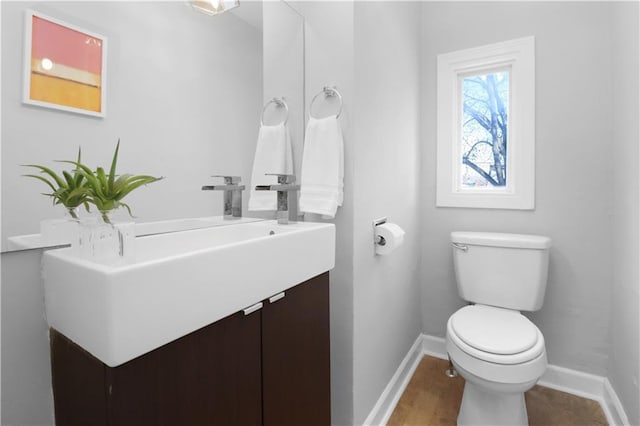 bathroom featuring toilet and vanity