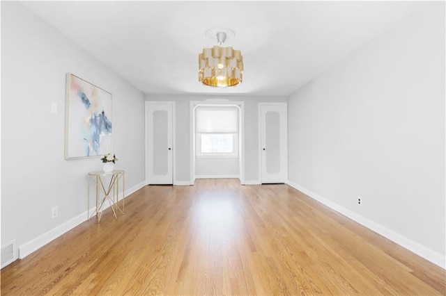 interior space with an inviting chandelier and light wood-type flooring